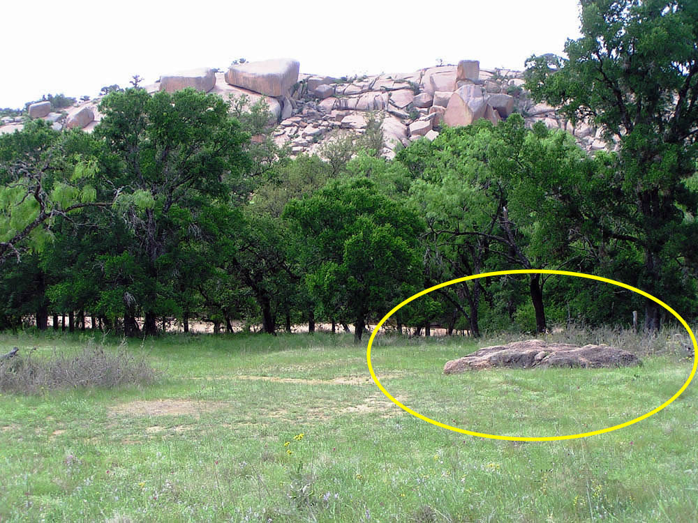 Granite mortar in the foreground of Enchanted Rock, Texas